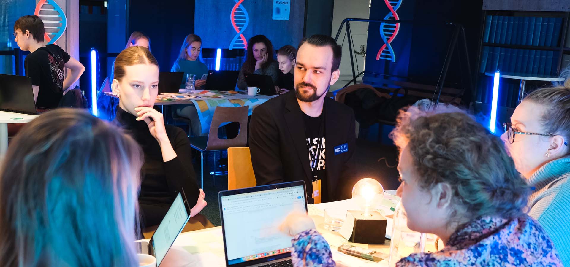 Participants collaborating in teams at PsyHack 2023, a psychology hackathon focused on real-world challenges.